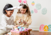 two girls looking at their easter baskets